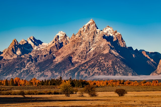 Grand Teton is a large national park in Wyoming, with many mountains and desolate areas.