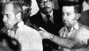 Tony Kiritis holding Richard O. Hall at gunpoint