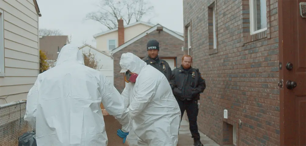 Two crime scene cleaners working next to two police officers